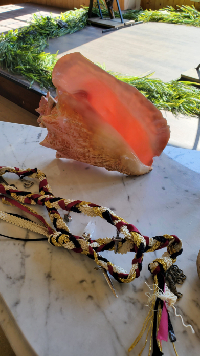 Viking wedding altar setup with conch shell, handfasting cords, and ritual table indoors