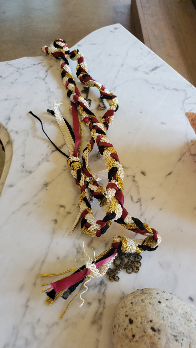 Close-up of Viking handfasting cords with beads and symbolic ornaments