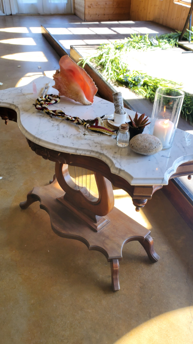 Viking wedding altar table with candle, conch shell, sage, and ceremonial items