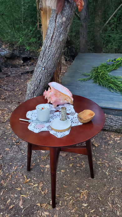 Viking ritual table outdoors with conch shell, candle, and ceremonial objects